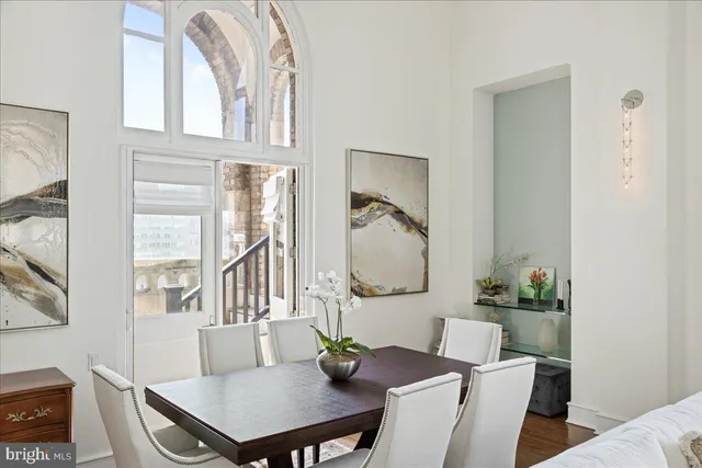 a living room with furniture and a mirror