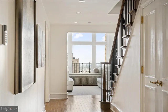 a view of an entryway with wooden floor and door