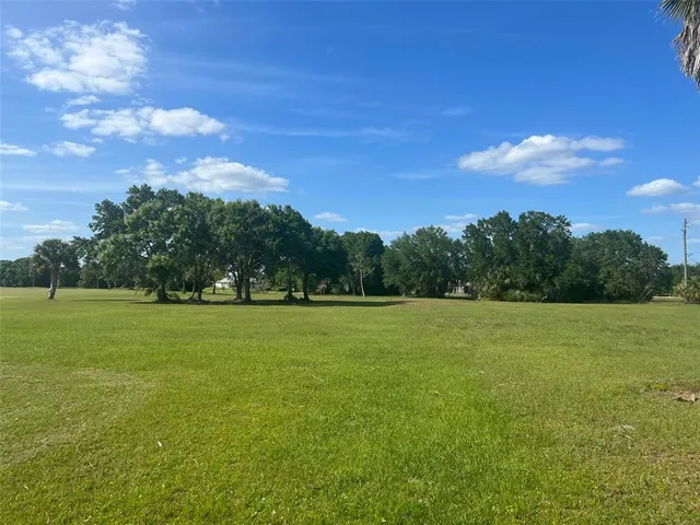 a view of field with trees in the background