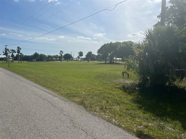a view of a field with an ocean