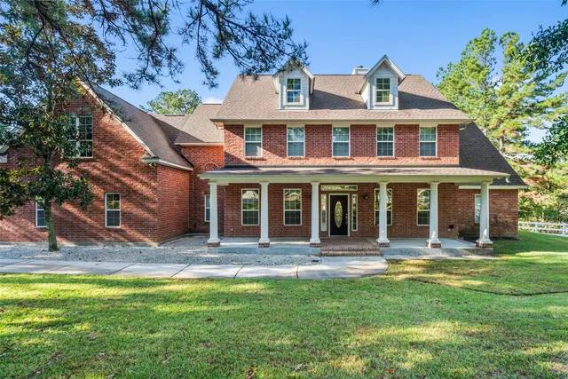 a view of a balcony with chairs and potted plants