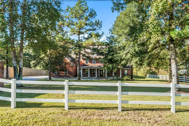 a view of a livingroom with a fireplace window and wooden floor