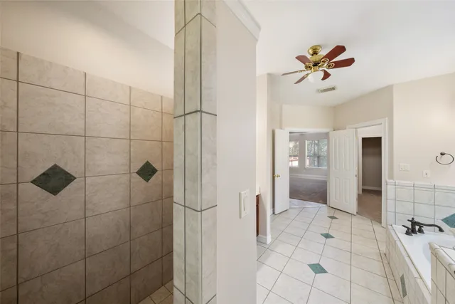 an aerial view of a house with swimming pool and large trees