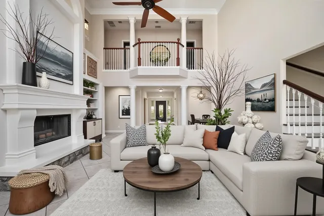 a spacious bedroom with a large bed and a chandelier fan