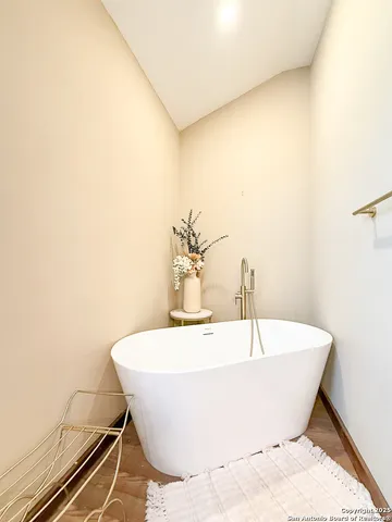 a white bath tub sitting in a bathroom