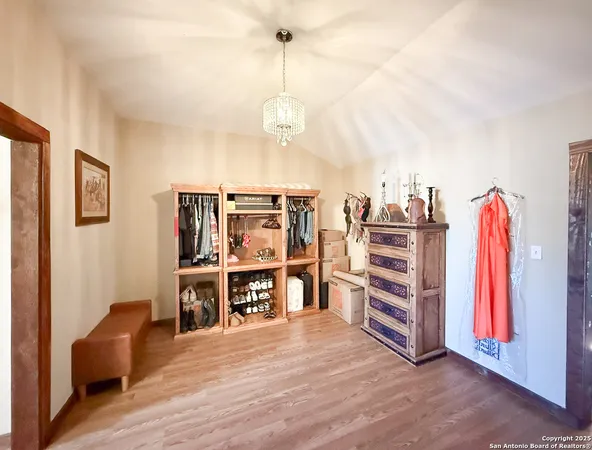 a view of a room with furniture and wooden floor