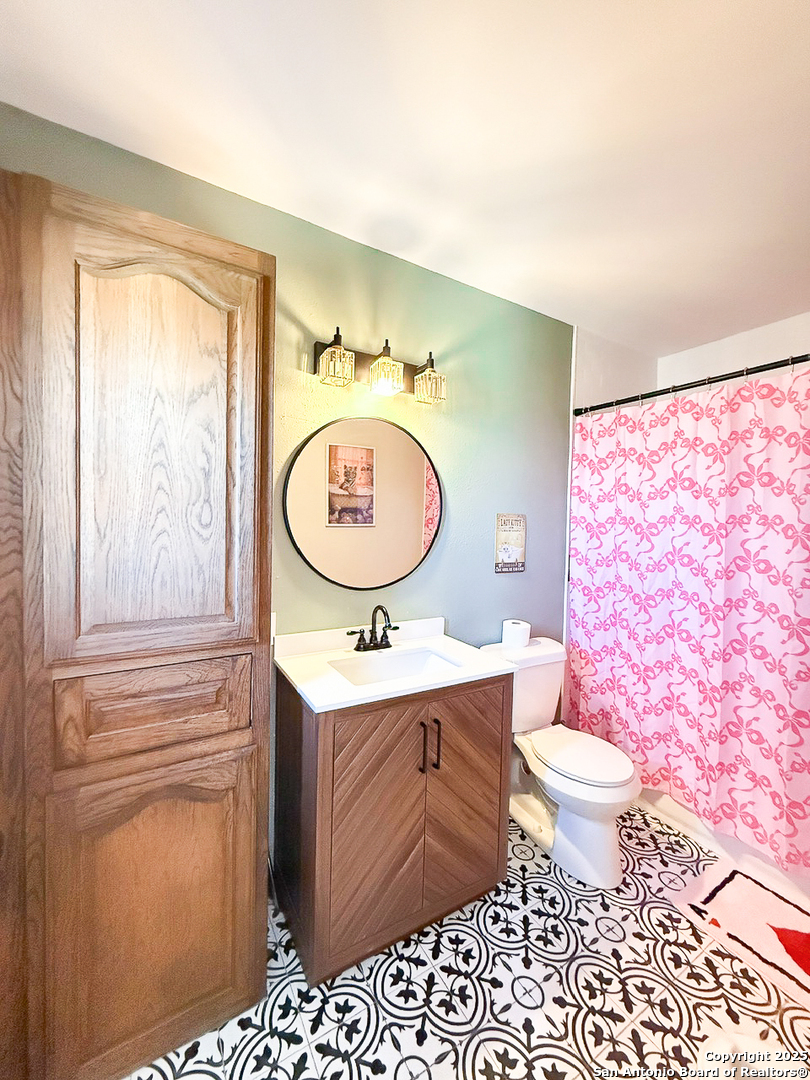 200 Pr 6631 Devine, TX 78016 - Photo 22 of 41 a bathroom with a toilet a sink and a mirror