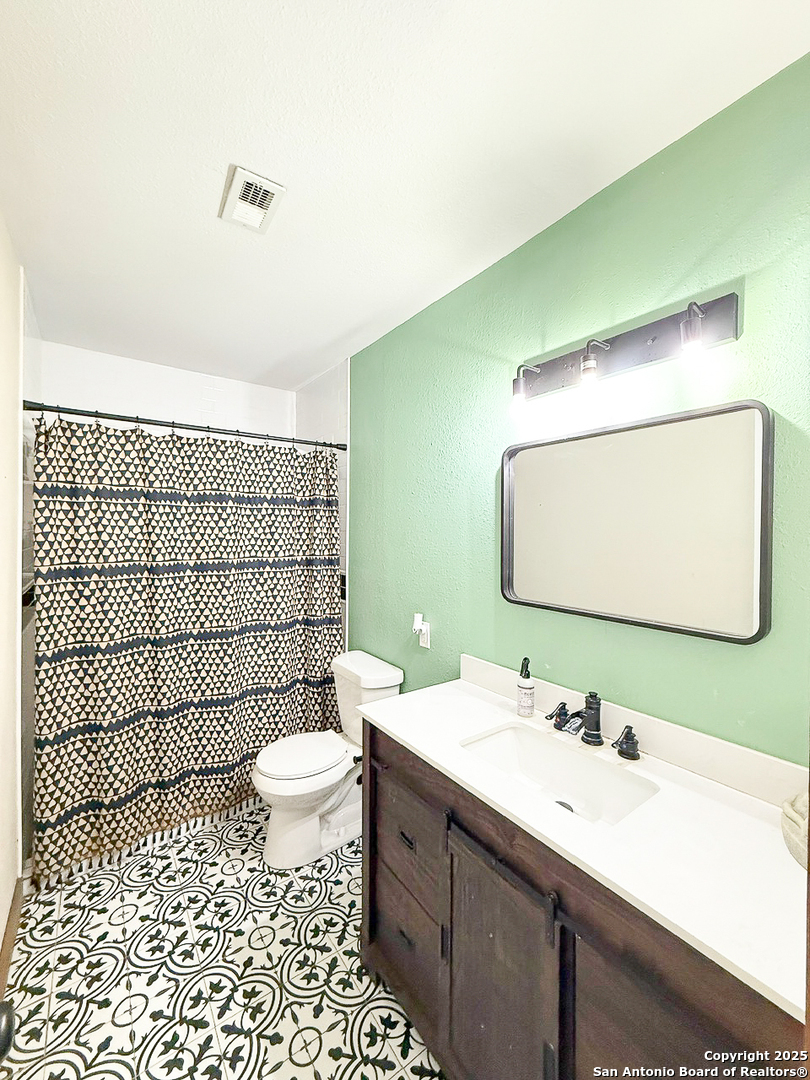 200 Pr 6631 Devine, TX 78016 - Photo 25 of 41 a bathroom with a sink mirror toilet and shower