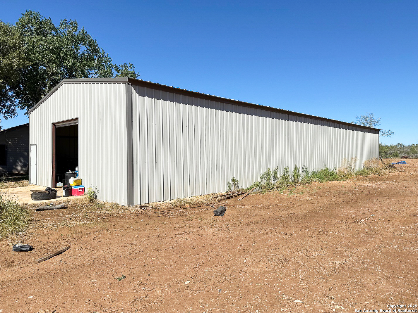 200 Pr 6631 Devine, TX 78016 - Photo 33 of 41 a backyard of a house with garage and outdoor seating
