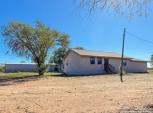a house that has a tree in front of it