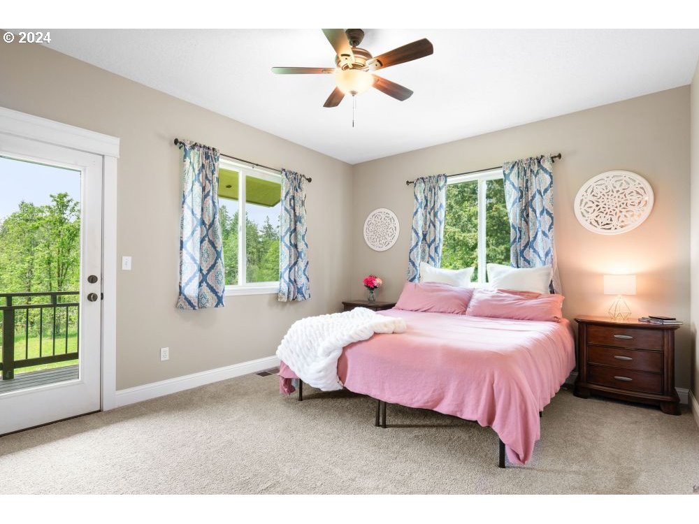 6034 Treehouse Road Monmouth, OR 97361 - Photo 11 of 45 a bedroom with a bed and a chandelier