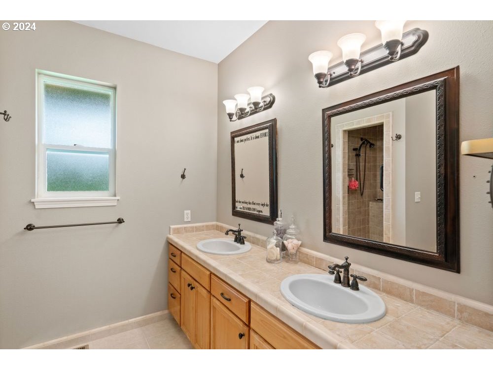 6034 Treehouse Road Monmouth, OR 97361 - Photo 13 of 45 a bathroom with a double vanity sink and a mirror