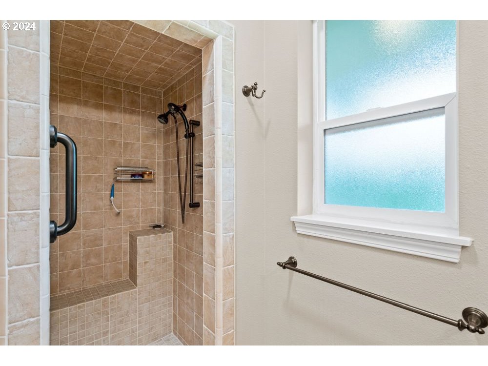 6034 Treehouse Road Monmouth, OR 97361 - Photo 14 of 45 a bathroom with a shower and a mirror