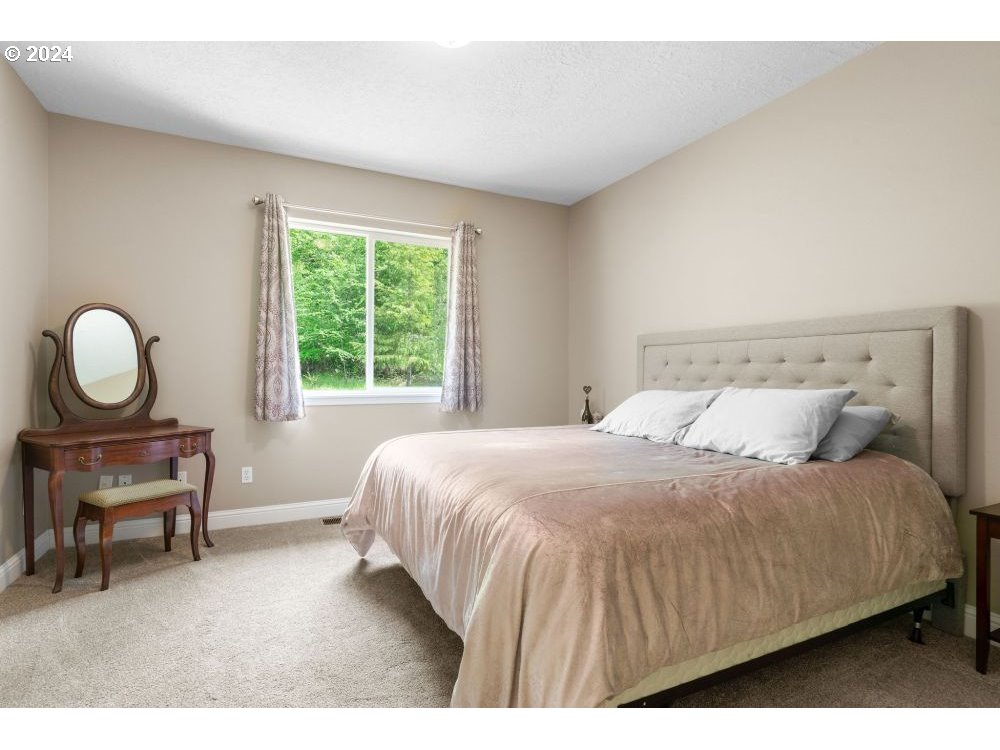 6034 Treehouse Road Monmouth, OR 97361 - Photo 15 of 45 a bedroom with a bed and a table