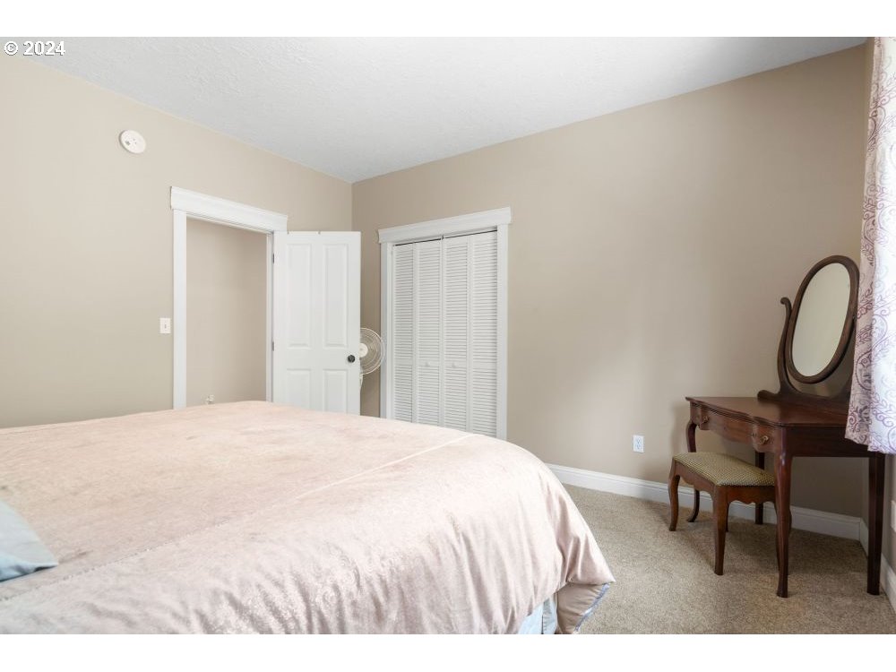 6034 Treehouse Road Monmouth, OR 97361 - Photo 16 of 45 a bedroom with a bed a table and chair