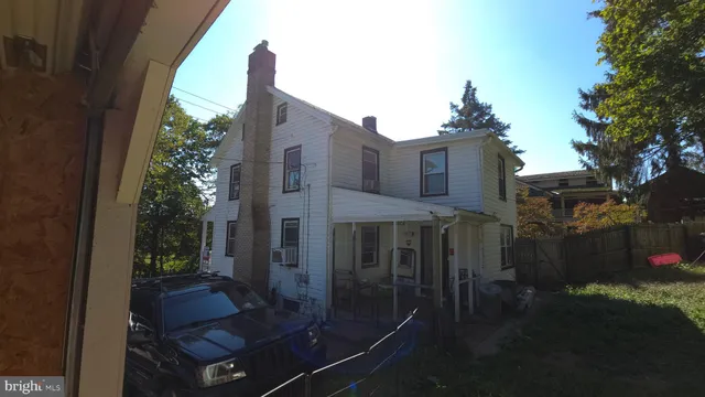 a view of a room with wooden floor and a window