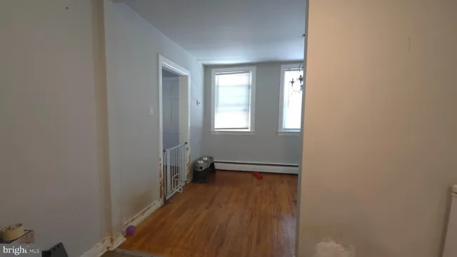 a room with wooden floor and fireplace