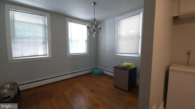 a room with a mirror and a wooden floor