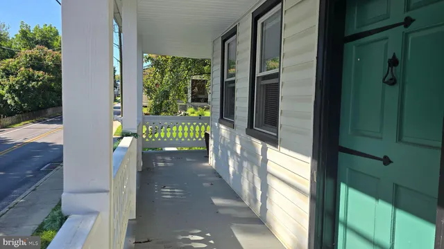 a backyard of a house with plants and large trees