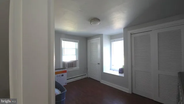 a view of a hallway with wooden floor and stairs