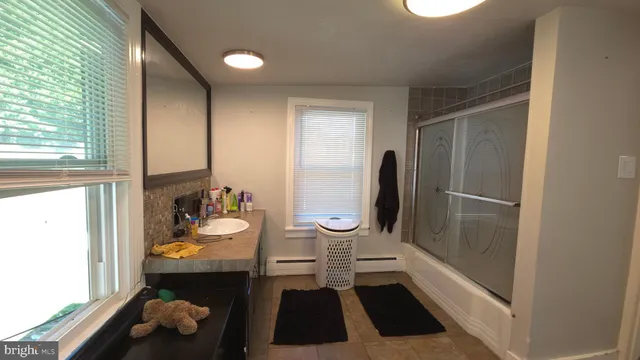 a bathroom with a toilet and a shower curtain