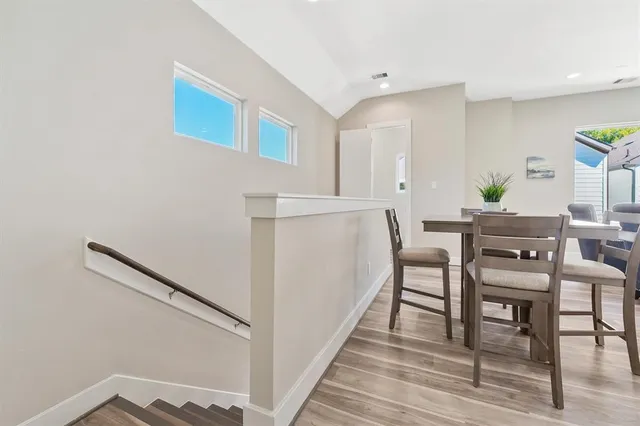 a dining room with furniture and wooden floor