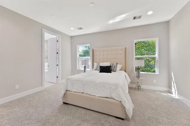 a spacious bedroom with a bed and a window