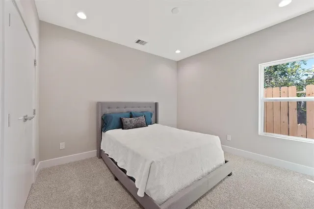 a bedroom with a bed and window