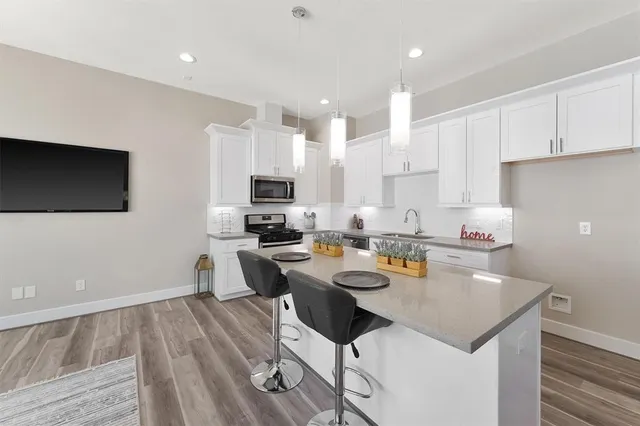 a kitchen with a dining table chairs and microwave