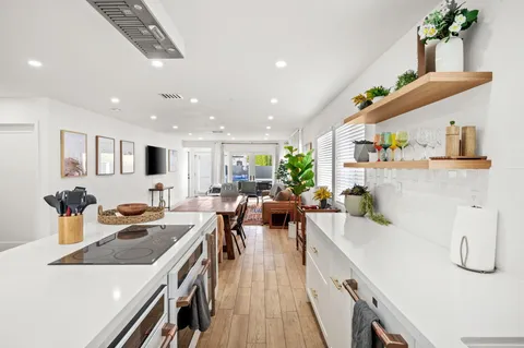 a kitchen with stainless steel appliances lots of counter space and a sink