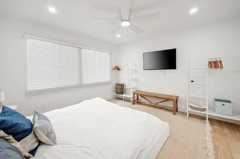 a bedroom with a bed and a flat screen tv