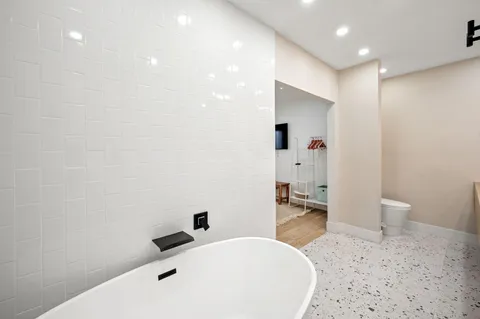 a bathroom with a sink a toilet and shower