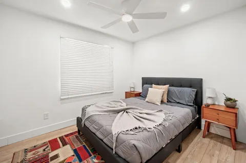 a bedroom with a bed and window