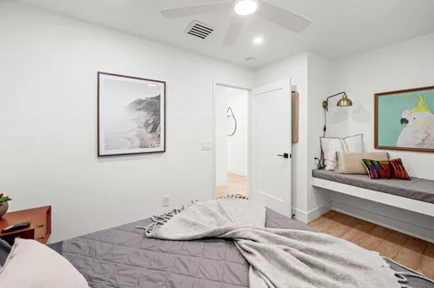 a bedroom with a bed and wooden floor