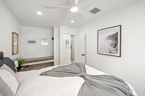 a bedroom with a large bed and a chandelier