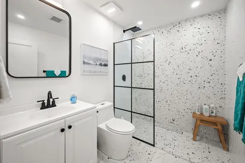 a bathroom with a toilet sink and a shower