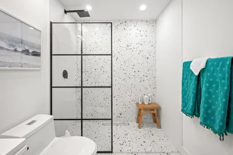 a bathroom with a toilet sink and shower