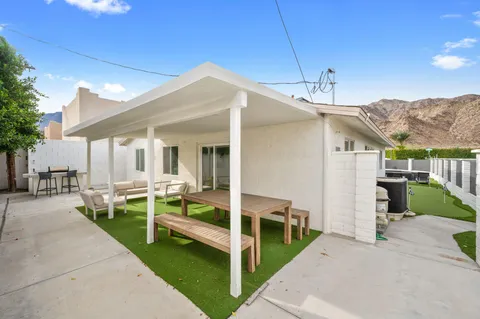 a view of a patio with couches table chairs and a fire pit