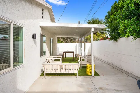 a front view of a house with outdoor seating