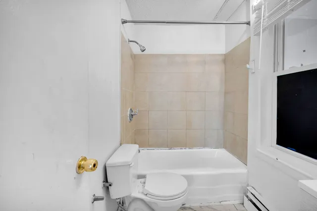 a bathroom with a toilet and shower