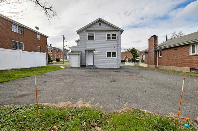 a view of a house with a yard and garage
