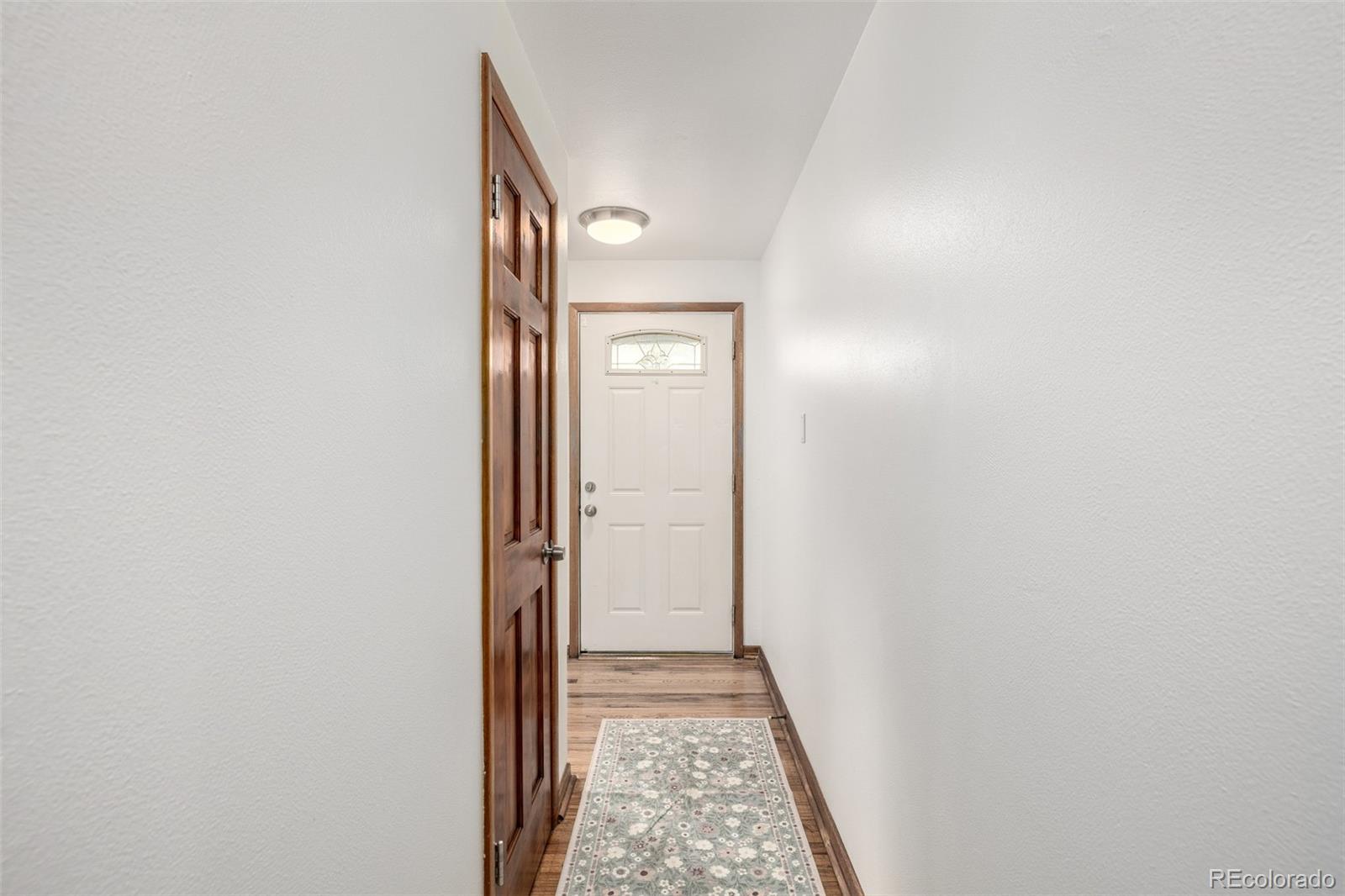 10095 West 41st Avenue Wheat Ridge, CO 80033 - Photo 13 of 37 a view of a hallway with wooden floor