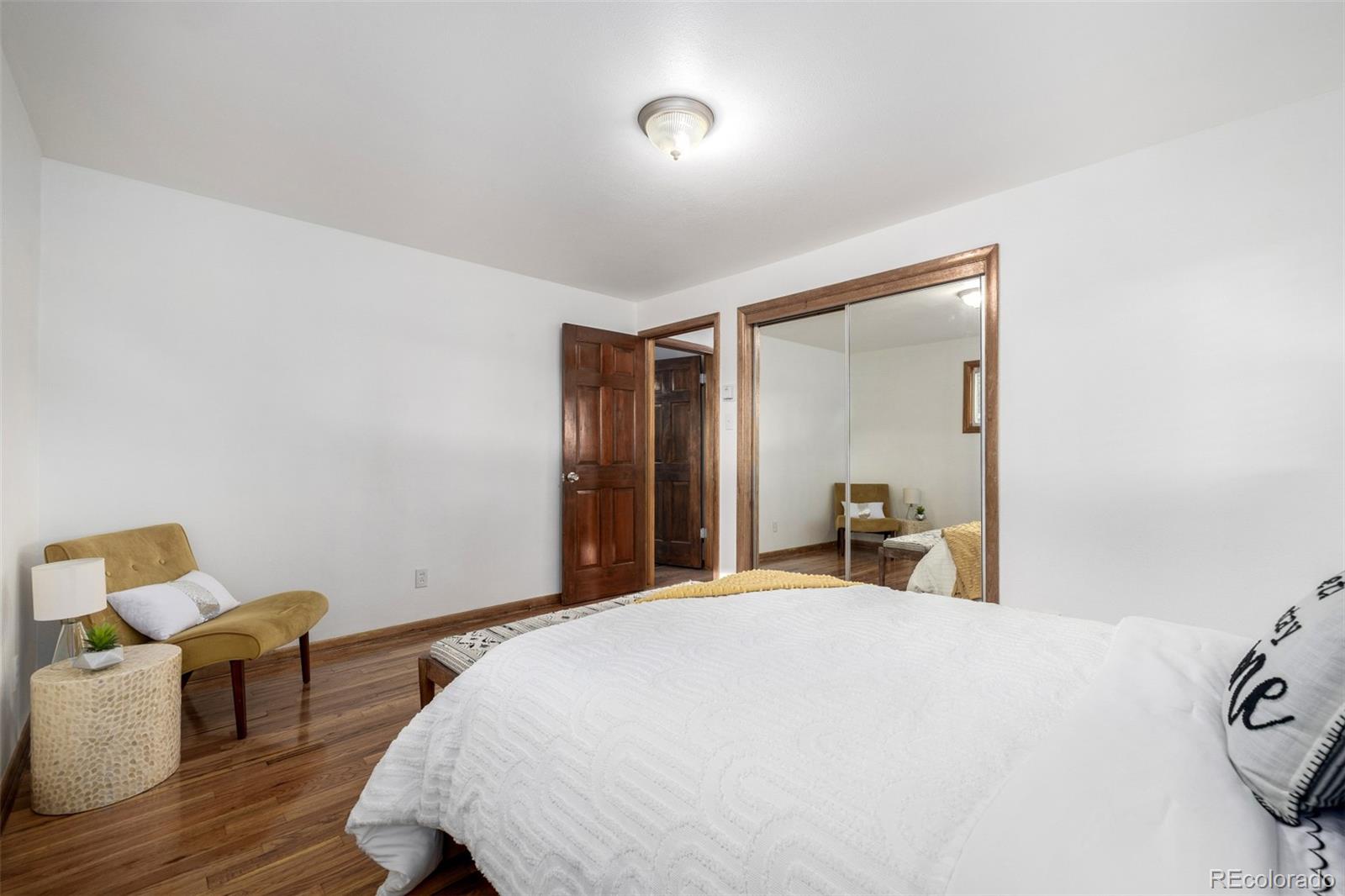 10095 West 41st Avenue Wheat Ridge, CO 80033 - Photo 16 of 37 a bedroom with a bed and wooden floor