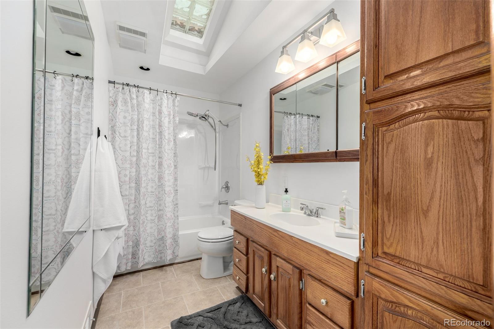 10095 West 41st Avenue Wheat Ridge, CO 80033 - Photo 17 of 37 a bathroom with a double vanity sink toilet and shower