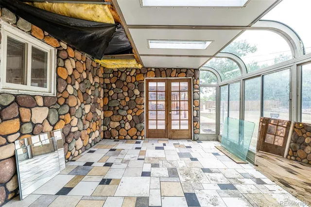 a view of a porch with a patio and glass door