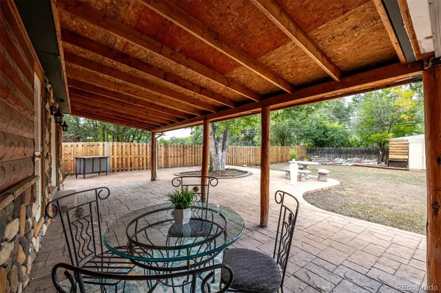 a dining room with furniture wooden floor and a garden