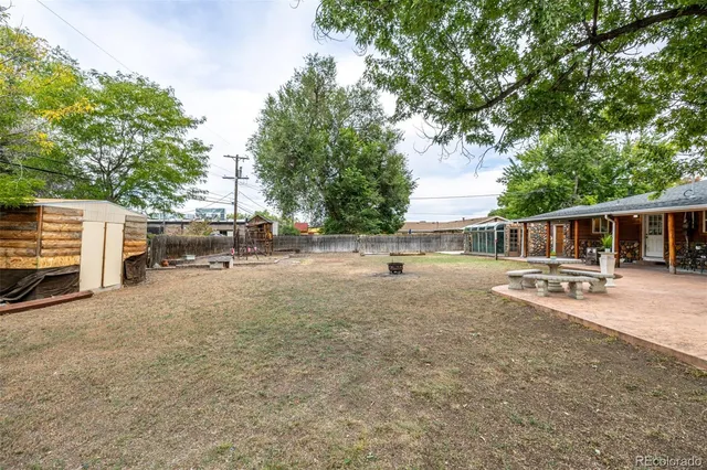 a view of a house with backyard and sitting area