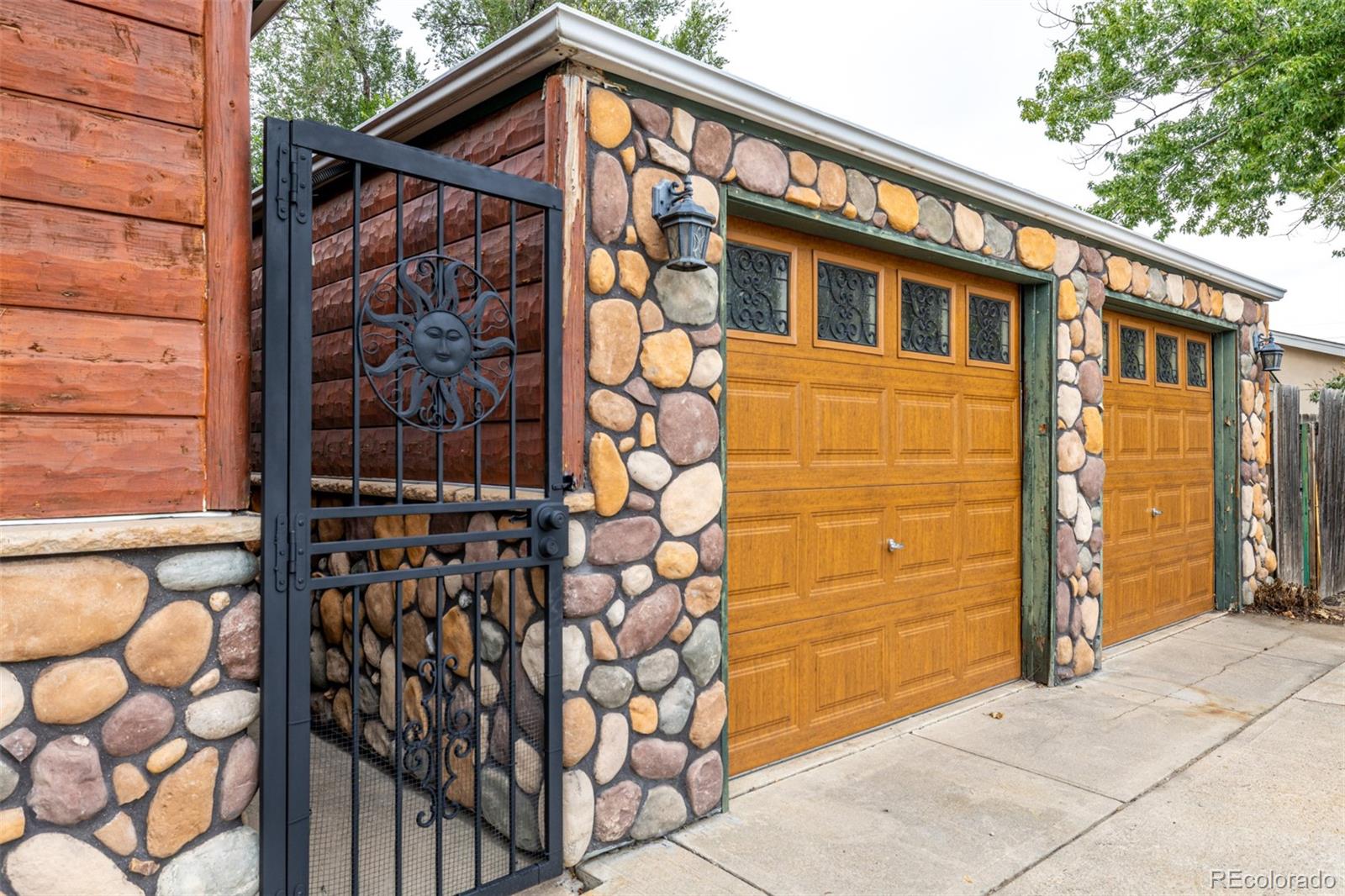 10095 West 41st Avenue Wheat Ridge, CO 80033 - Photo 4 of 37 a front view of a house with a garage
