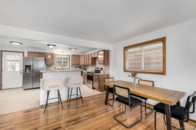 a dining room with wooden floor and breakfast area