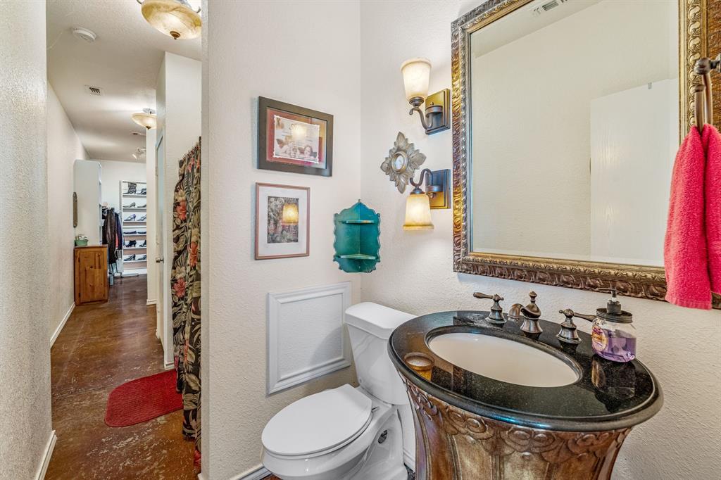 255 Baughman Hill Road Azle, TX 76020 - Photo 17 of 40 a bathroom with a toilet sink and mirror